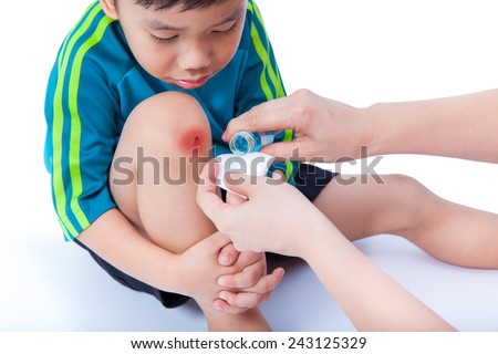 stock-photo-little-asian-thai-boy-in-sportswear-looking-wound-his-leg-nurse-provides-first-aid-on-white-243125329.jpg