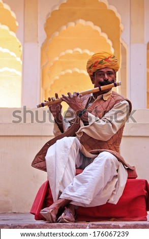 JODHPUR, INDIA - FEBRUARY 11: An unidentified man plays flute in Mehrangarh Fort on February 11, 2011 in Jodhpur, India. Mehrangarh Fort is one of the largest forts in India. - stock photo
