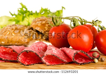Salami sandwich ingredients: salami slices, tomatoes, bread, salad ...