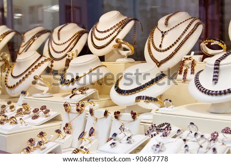 counter with garnet jewelry in store window - stock photo