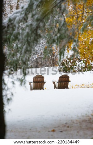 Two empty adirondack chairs on an early snowfall in the autumn, Stowe 