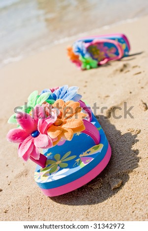 pair of a lovely flower decorated flip flops for child girl, left on ...