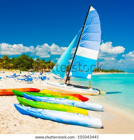 Colorful kayaks and sailing boats for rent at the beautiful beach of 