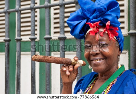 HAVANA-MAY 19:Lady smoking a huge cigar May 19,2011 in Havana.Iconic characters like this are an attraction for the more than 2 million tourists who go to Cuba each year to enjoy its distinct culture - stock photo