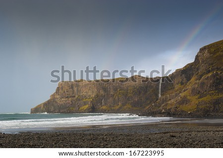  - stock-photo-a-rainbow-appearing-over-the-waterfall-on-talisker-bay-syke-on-a-stormy-winters-day-167223995
