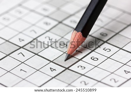 crossword sudoku and pencil, popular puzzle game with numbers - stock photo