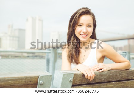 http://thumb7.shutterstock.com/display_pic_with_logo/1993499/350248775/stock-photo-beautiful-american-girl-portrait-in-new-york-city-sitting-in-pier-and-enjoying-the-skyline-view-350248775.jpg