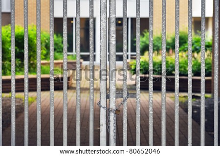 Gated residential community, locked fence with padlock and chain 