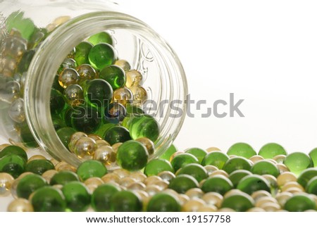 stock-photo-green-and-gold-marbles-spill
