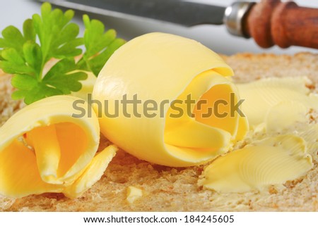 stock-photo-slice-of-toast-bread-with-a-curl-of-butter-184245605.jpg