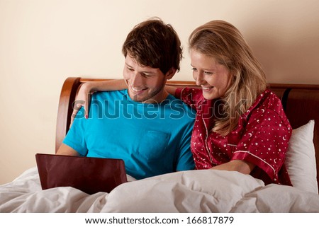 http://thumb7.shutterstock.com/display_pic_with_logo/277009/166817879/stock-photo-couple-watching-together-the-movie-in-bed-before-going-to-sleep-166817879.jpg