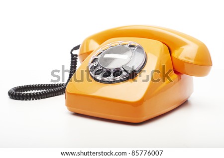 vintage orange telephone isolated over white background - stock photo
