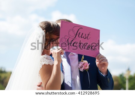http://thumb7.shutterstock.com/display_pic_with_logo/2951464/412928695/stock-photo-just-married-happy-couple-wedding-celebration-newlyweds-are-kissing-with-a-sign-just-married-in-412928695.jpg