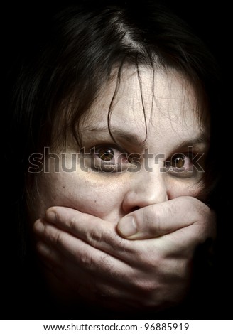Victim of violence. Focus on the eyes. High contrast. - stock photo