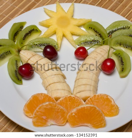 stock-photo-creative-fruit-dessert-with-kiwi-banana-cherry-and-orange-palm-tree-shape-134152391.jpg