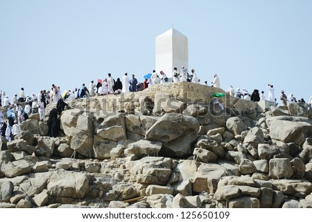 MECCA - JULY 21 : Jabal Arafat near Kaaba on July 21, 2012 in Mecca, Saudi Arabia.  Kaaba in Mecca is the holiest and most visited mosque for all Muslims and standing on Arafat is a part of Hajj. - stock photo