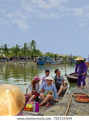HOI AN, VIETNAM - OCTOBER 04, 2015: Tourists In Boat about to take tour of Hoi An Old Town Canal.