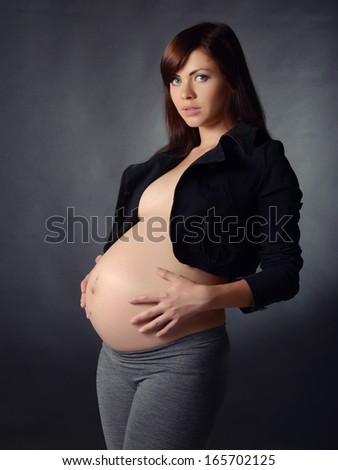 http://thumb7.shutterstock.com/display_pic_with_logo/428887/165702125/stock-photo-very-beautiful-pregnant-woman-on-dark-background-165702125.jpg