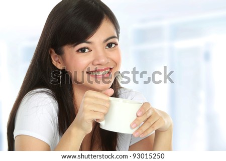 Closeup of charming Asian woman having tea - stock photo - stock-photo-closeup-of-charming-asian-woman-having-tea-93015250