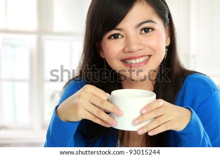 Closeup of charming Asian woman having tea - stock photo - stock-photo-closeup-of-charming-asian-woman-having-tea-93015244