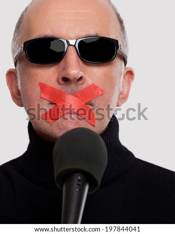 Man with tape over his mouth - stock photo - stock-photo-man-with-tape-over-his-mouth-197844041