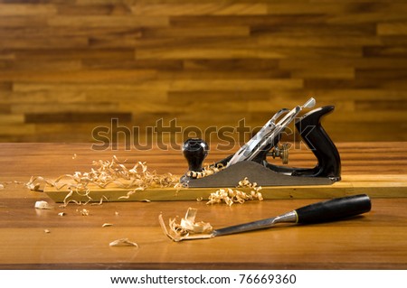 Wood planer on workbench with wood shavings. - stock photo