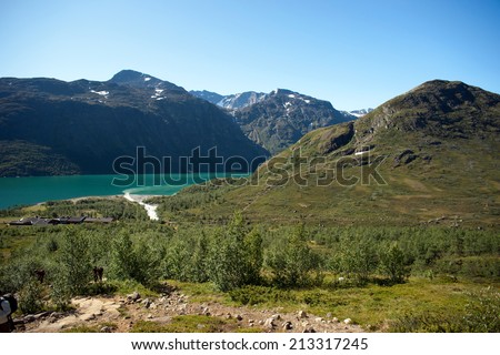 BESSEGEN, NORWAY - JULY 22, 2013: Hikers taking route through ridge at ...