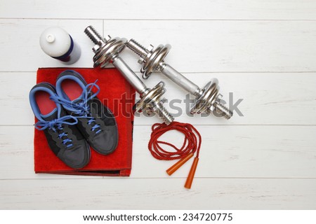 fitness equipment on white wooden plank floor - stock photo