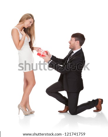 http://thumb7.shutterstock.com/display_pic_with_logo/514156/121741759/stock-photo-smart-guy-kneeled-on-his-knees-then-gives-gift-to-wife-121741759.jpg