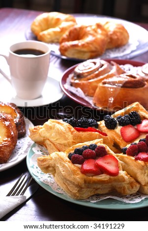 stock-photo-plates-of-assorted-pastries-with-coffee-at-cafe-34191229.jpg