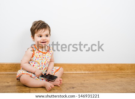  - stock-photo-pretty-baby-smiling-and-texting-while-looking-away-146931221