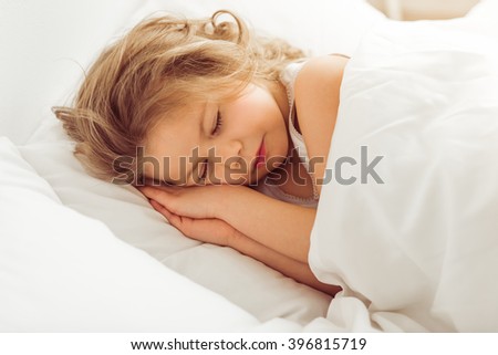 pic stock photo gigging young adult woman wearing jeans and sweater in prone position on white sofa pic stock photo gigging young adult woman wearing jeans and sweater in prone position on white sofa