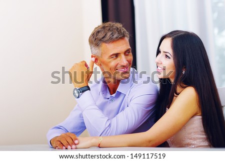 stock photo happy beautiful couple sitting at the table at home 149117519