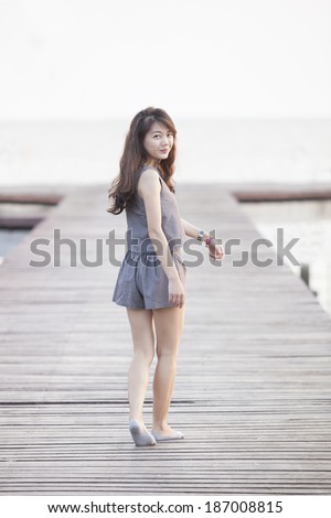 http://thumb7.shutterstock.com/display_pic_with_logo/607489/187008815/stock-photo-beautiful-asian-woman-walking-on-wood-pier-with-relaxing-emotion-and-smiling-to-camera-use-for-187008815.jpg