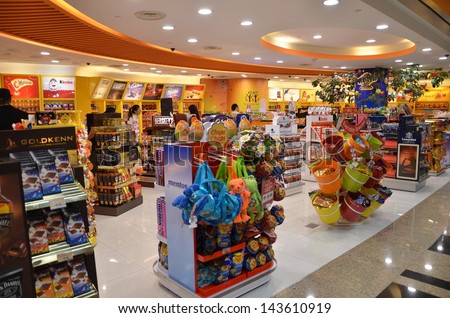 SINGAPORE-JUNE 14: Customers shop for toys in Changi Airport, Singapore on June 14, 2013. Singapore airport provides the best shopping experience to the passengers. - stock photo