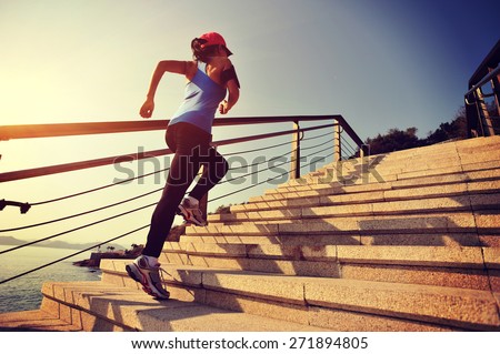 healthy lifestyle sports woman running up on stone stairs sunrise ...