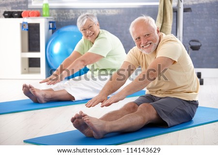 stock-photo-elderly-couple-stretching-in-the-gym-114143629.jpg