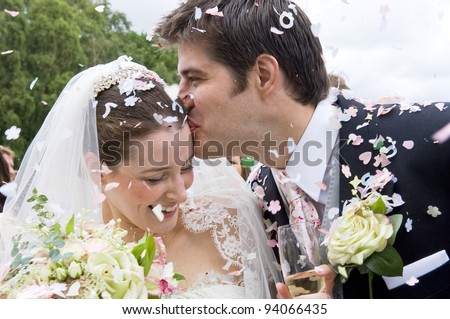 http://thumb7.shutterstock.com/display_pic_with_logo/661207/661207,1328091061,1/stock-photo-a-really-happy-looking-bride-and-groom-being-showered-with-confetti-by-their-guests-94066435.jpg