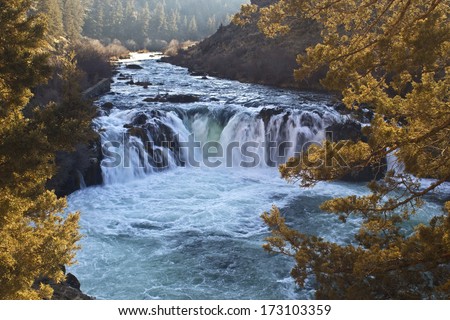  - stock-photo-beautiful-steelhead-falls-oregon-on-a-sunny-day-in-winter-with-aqua-glacier-water-173103359