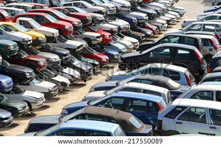 stock-photo-several-cars-destroyed-in-the-courtyard-of-the-automobile-junkyard-217550089.jpg