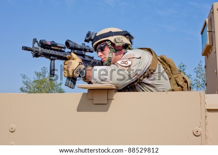 KUWAIT - JANUARY 17: U.S. Navy EOD aims his rifle from a humvee during ...