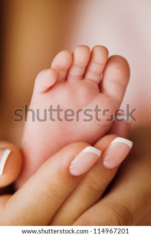 Masseur+Search Masseur massaging little baby's foot, shallow focus - stock photo