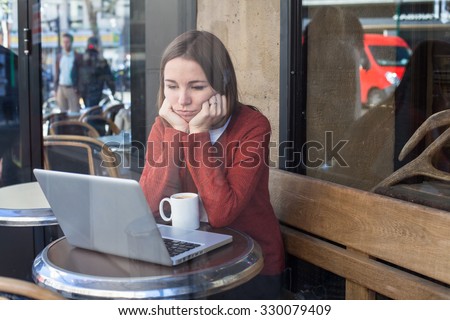 envy concept, bored sad woman in front of computer - stock photo