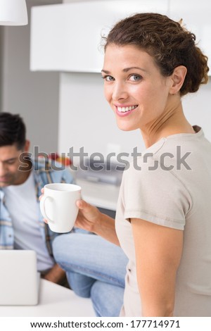 http://thumb7.shutterstock.com/display_pic_with_logo/76219/177714971/stock-photo-cheerful-woman-drinking-coffee-while-partners-uses-laptop-at-home-in-kitchen-177714971.jpg