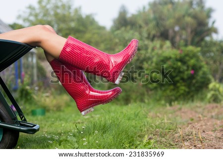 http://thumb7.shutterstock.com/display_pic_with_logo/76219/231835969/stock-photo-woman-in-welly-boots-in-wheelbarrow-at-home-in-the-garden-231835969.jpg