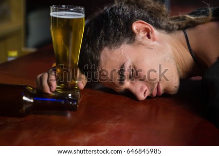 http://thumb7.shutterstock.com/display_pic_with_logo/76219/646845985/stock-photo-drunk-man-sleeping-on-bar-counter-646845985.jpg