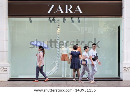 SHANGHAI-JUNE 6. People pass Zara outlet. Zara owner, Spain Inditex ...