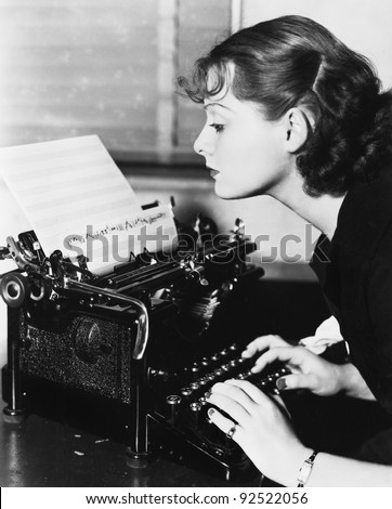 Profile of a young woman typing musical notes with a typewriter - stock photo