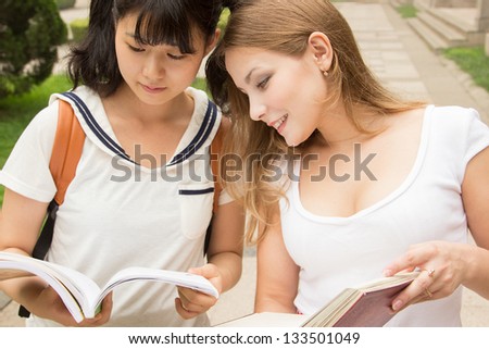 http://thumb7.shutterstock.com/display_pic_with_logo/971602/133501049/stock-photo-european-and-asian-girls-studying-together-teamwork-of-students-133501049.jpg