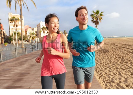 couple jogging on Barcelona Beach, Barceloneta. Healthy lifestyle ...
